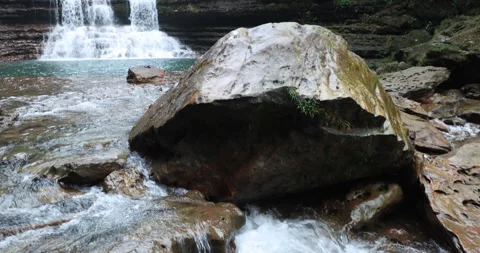 Water running Through mossy rocks Stock Footage 335354015