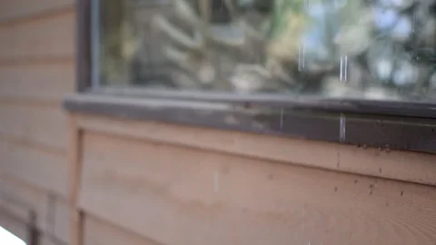 Water running by a window with focus pull Stock Footage 87477656