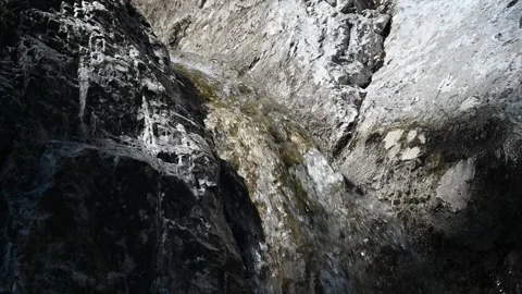 Water runs down between rocks in summer (slow motion) Stock Footage 219645944