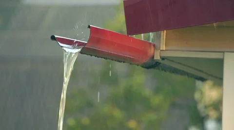 Water runs down the gutter along the roof in heavy rain Stock Footage 66445427