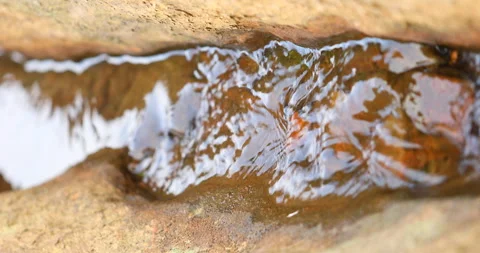 Water Runs on a Stone Stockbeeldmateriaal 335675236