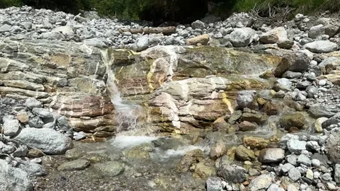 Water Rushing Down Rocks In Mountain Stream Video stock 279565877