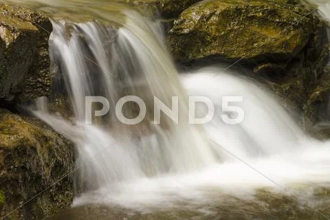 Water rushing over rocks Stock Photos