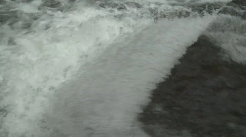 Water rushing over small dam Stock Footage 25510450