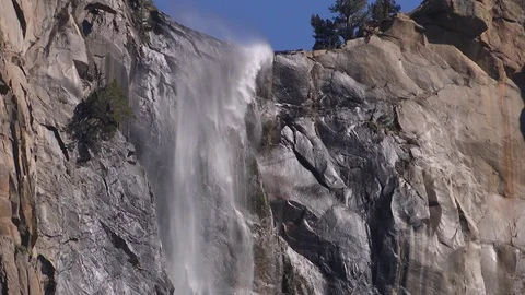 Water rushing over stone cliff in spring Bridalveil Fall Yosemite Valley Stock Footage 99087212