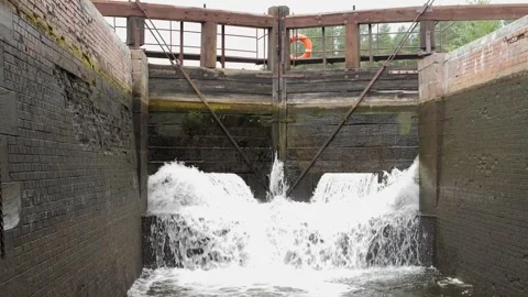 Water rushing through open lock gates on canal Stock Footage 282668382