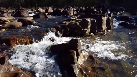 Water rushing through rocks on a river, fast current (in 4K) 스톡 동영상 74062885