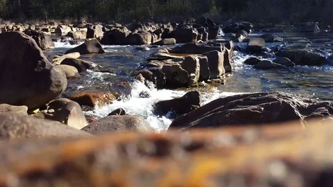 Water rushing through rocks on a river strong current 스톡 동영상 74062951