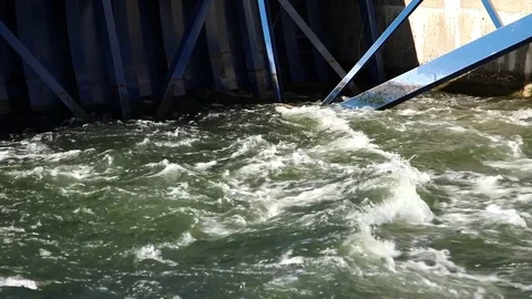 Water rushing under a bridge Stock Footage 83990793
