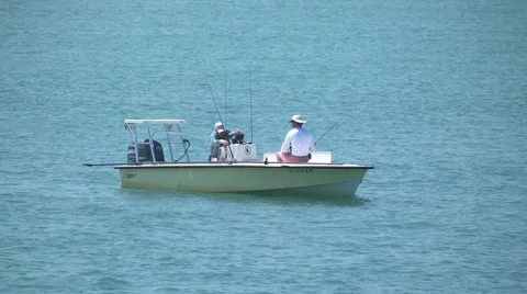 Water scenic men sitting in a yellow flats boat putting rods away 1 h264 Stock Footage