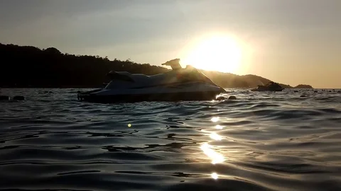 Water scooter rolling on waves on sunset rays. Stock Footage 126265606
