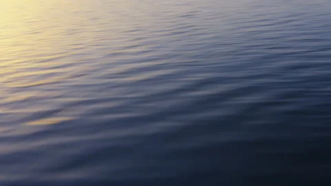 The water scrolls from a boat on Lake Geneva at sunrise, in Switzerland Stock Footage 229804632