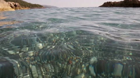 Water sea surface with rippling waves. Transparent sea water with pebble bottom Stock Footage 154262296