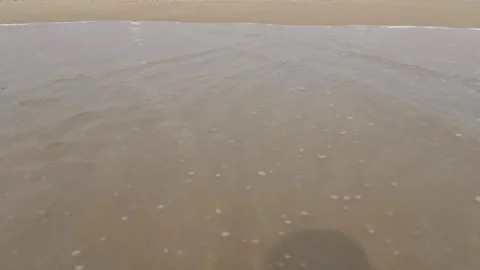 Water from sea waves going back to see after hitting the beach Vidéo 331114461
