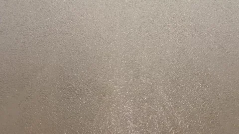 Water from sea waves going back to see after hitting the beach 스톡 동영상 331114476