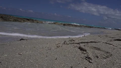 The water seems so close beneath a beautifully fine and lovely sand. 動画素材 305132478