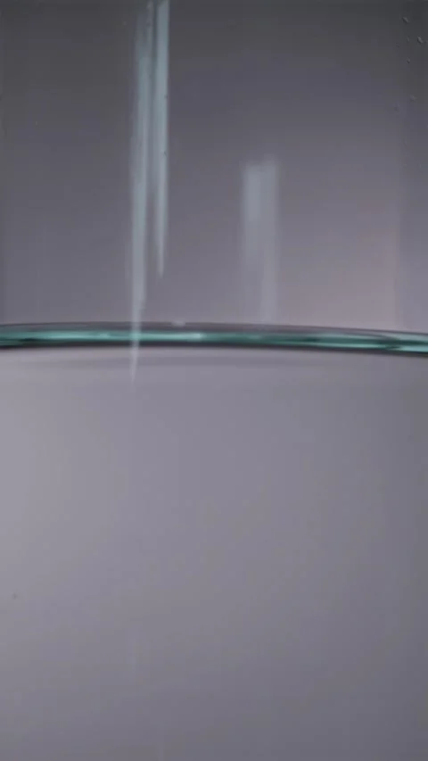 Water shaking inside glass carafe during earthquake simulation macro Video stock 344877164