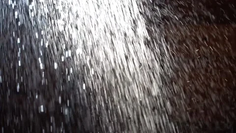 Water shower ON A DARK BACKGROUND Stock Footage 144367487