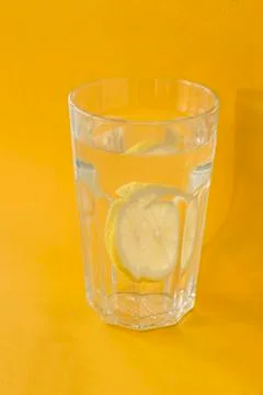 Water with a slice of a lemon Stock Photos