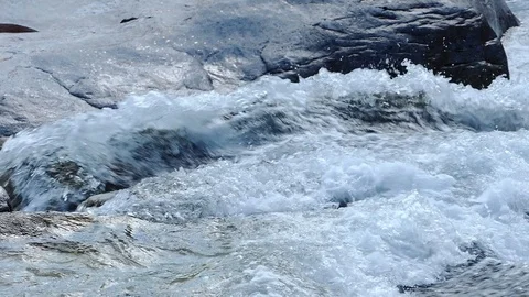Water slow-motion shot of a stream forming waves and swirls 動画素材 114178226