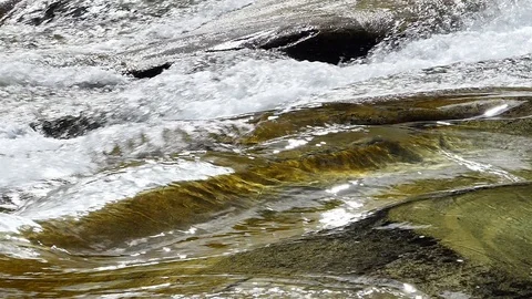 Water slow-motion shot of a stream forming waves and swirls 動画素材 114178397