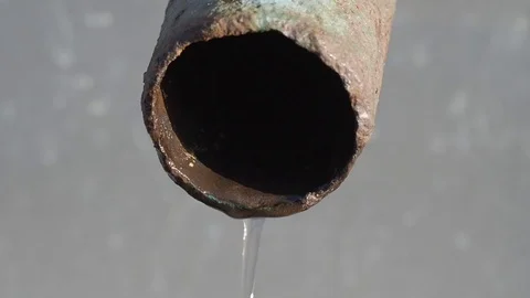 Water slowly dripping from an old rusty corpse. Close up Stock Footage 123237075