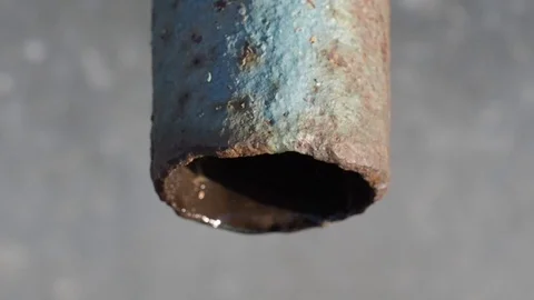 Water slowly dripping from an old rusty corpse. Close up, top view Stock Footage 123237472