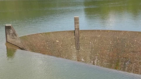 Water slowly falls from a reservoir into an overflow Stock Footage