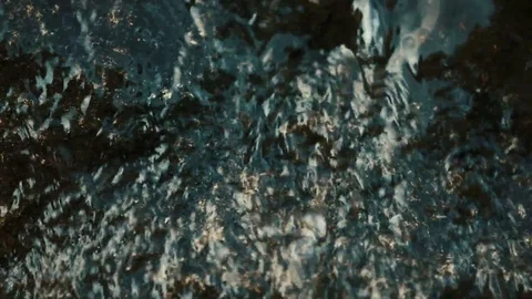 The water slowly flows down the dark stone with the veins of gold. Slow motion Stock Footage 113068565