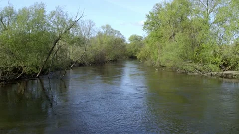 Water slowly ripples down the river. 4k60p Stock Footage 130814883