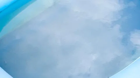 Water in a small pool with sky reflection. Stock Photos