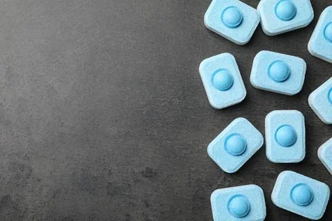 Water softener tablets on grey table, flat lay. Space for text Stockfoto's