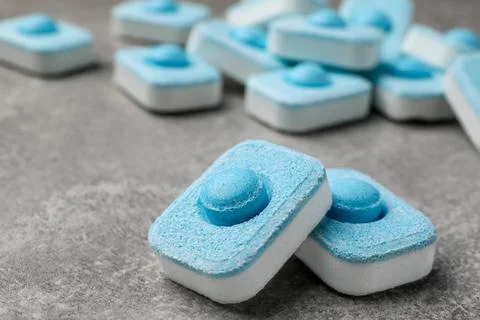 Water softener tablets on grey table, closeup. Space for text Stockfoto's