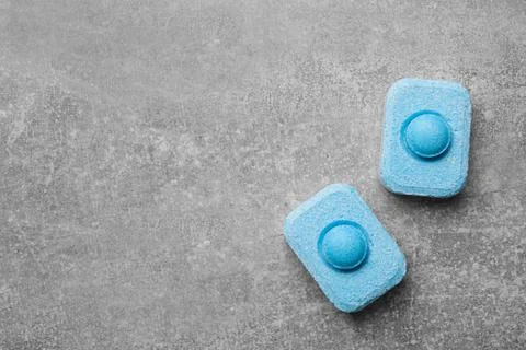 Water softener tablets on grey table, flat lay. Space for text Stock Photos