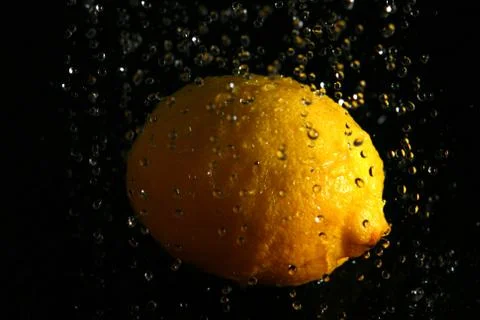 Water splash and lemon Stock Photos