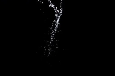 Water splash on black background Stock Photos