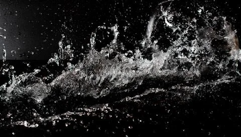 Water splash on black isolated background Stock Photos