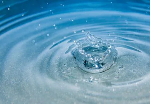 Water splash in blue background Stock Photos