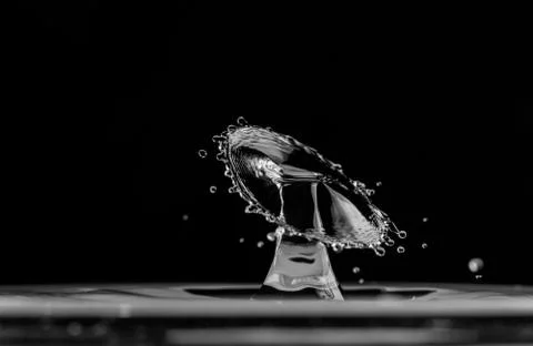 Water splash drop on black background Stock Photos
