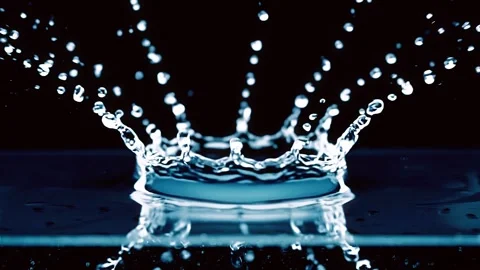 Water Splash Droplets on Dark Reflective Surface Stock Footage 345678909