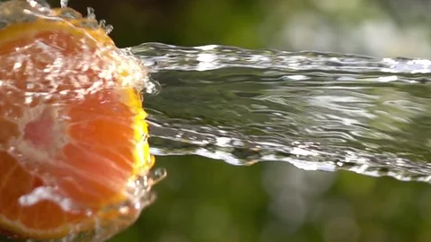 Water splash falling on slices orange slow motion Stock Footage 74284585