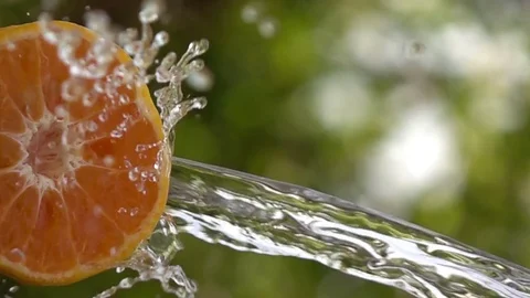 Water splash falling on slices orange slow motion Stock Footage 75836475