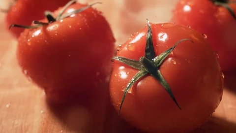 Water splash on fresh tomatoes on table. Slow Motion. Stock Footage 128958182