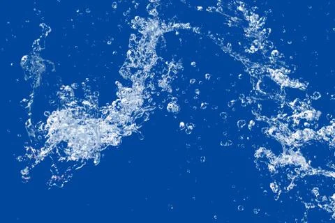 Water splash isolated on blue background Stock Photos