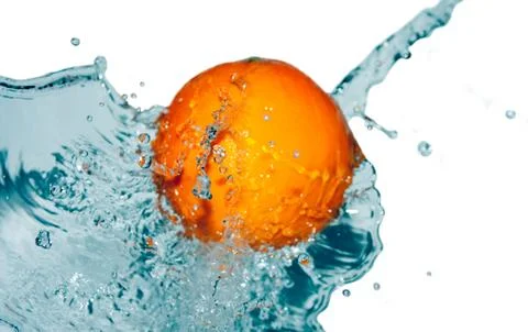 Water splash on orange Stock Photos