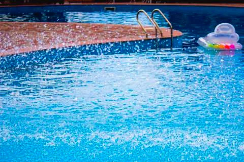 Water splash in the pool Stock Photos