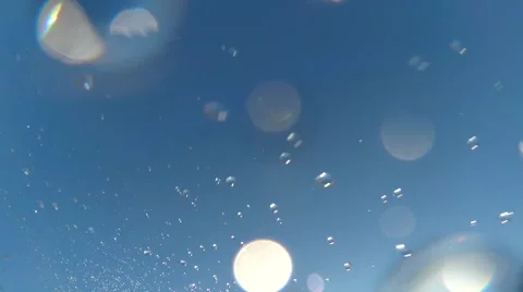 Water splashed against blue sky. Bokeh effect on glass Stock Footage 64219324