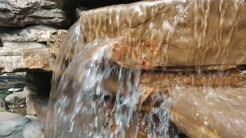 Water splashes and flows down the stones. Side view. Hot springs resort. Stock-Footage 153415597