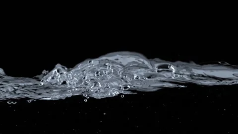 Water splashes and waves on balck background. Slow motion shot of water surface Stock Footage 237616171