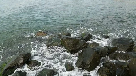 Water splashes in to beach rocks Stock Footage 40294700